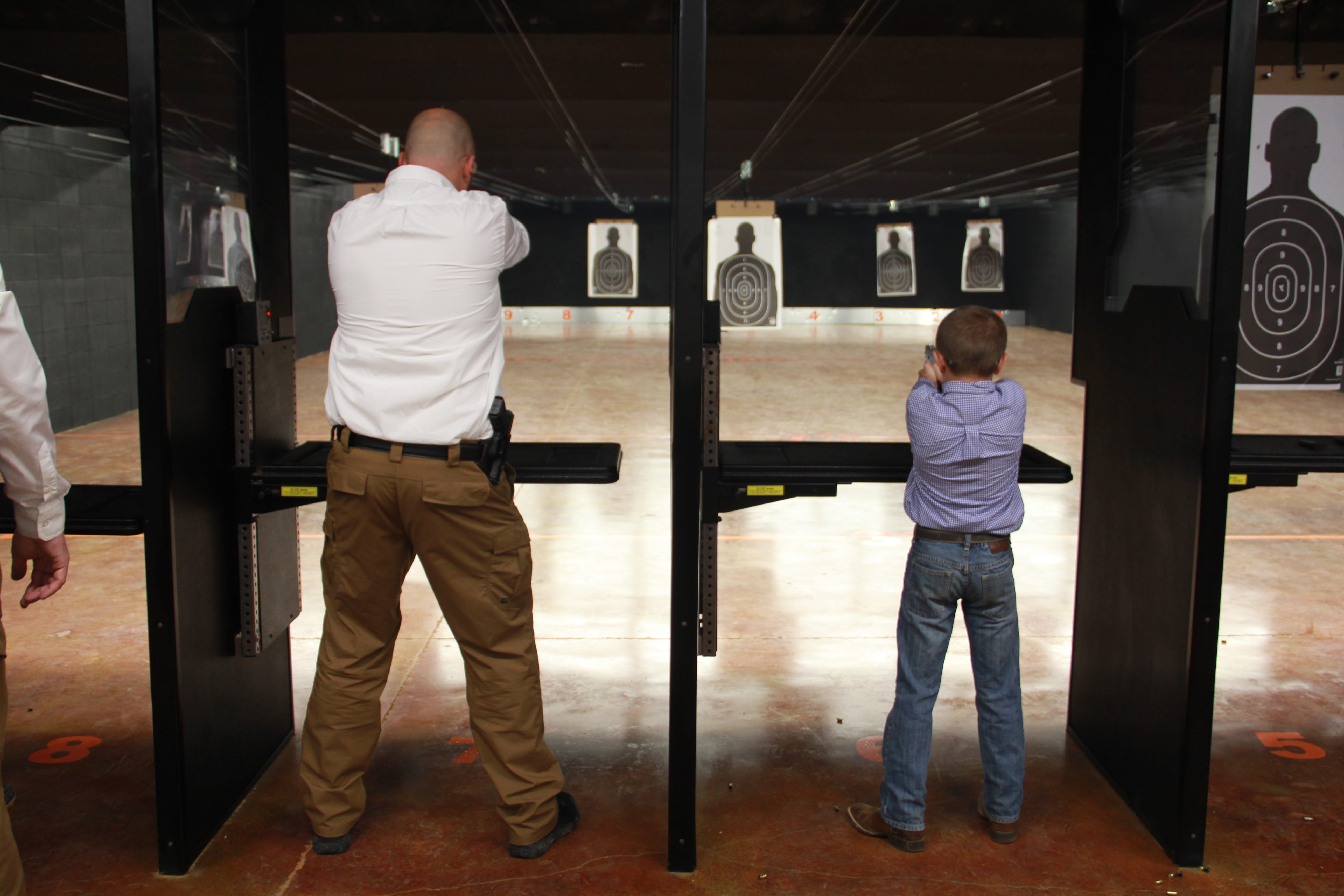 dad shooting with son fathers day indoor shooting range two gun tactical.